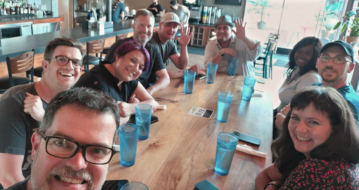 StellarWP leaders together around a table in Austin, TX.