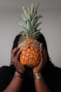 woman holding pineapple