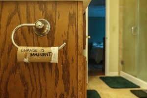 brass door knob on brown wooden door